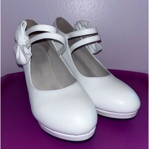 White heels with bow. Velcro band across the front.